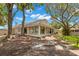 Relaxing outdoor living with covered porch, beautiful lawn, mature trees providing a serene backyard retreat at 5102 White Pine Ne Cir, St Petersburg, FL 33703
