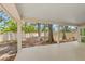 Covered outdoor patio overlooking a spacious backyard with mature trees and privacy fence at 5102 White Pine Ne Cir, St Petersburg, FL 33703