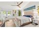 Bright main bedroom with a ceiling fan, stylish furnishings, and natural light, creating a cozy retreat at 5102 White Pine Ne Cir, St Petersburg, FL 33703