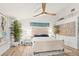 Bright and airy main bedroom with a ceiling fan, hardwood floors, and serene decor for ultimate relaxation at 5102 White Pine Ne Cir, St Petersburg, FL 33703