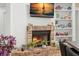 Close-up of a brick fireplace with built-in shelving and a mounted television at 5102 White Pine Ne Cir, St Petersburg, FL 33703