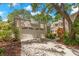 Exterior view showcasing a two-car garage, mature landscaping, and a well-maintained driveway at 5102 White Pine Ne Cir, St Petersburg, FL 33703
