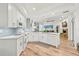 Bright kitchen with white cabinetry, updated appliances, and wood flooring at 5102 White Pine Ne Cir, St Petersburg, FL 33703