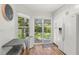 Bright kitchen featuring white cabinets, stainless steel refrigerator, and sliding glass door to the outdoor area at 5102 White Pine Ne Cir, St Petersburg, FL 33703