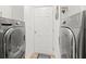 Convenient laundry room featuring a front load washer and dryer and direct access to outside at 5102 White Pine Ne Cir, St Petersburg, FL 33703
