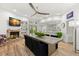 Open-concept living and dining room with wood floors, brick fireplace, and modern decor at 5102 White Pine Ne Cir, St Petersburg, FL 33703