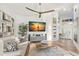 Bright living area with a large TV, modern decor, and comfortable seating at 5102 White Pine Ne Cir, St Petersburg, FL 33703