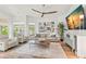 Spacious living room with stylish furnishings, a ceiling fan, and lots of natural light at 5102 White Pine Ne Cir, St Petersburg, FL 33703