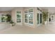 Enclosed outdoor patio with multiple windows and doors, surrounded by lush greenery at 5102 White Pine Ne Cir, St Petersburg, FL 33703
