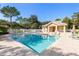 Community pool offers clear water, lounge chairs, and a shaded pavilion area for relaxation and leisure at 5102 White Pine Ne Cir, St Petersburg, FL 33703