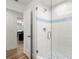 Updated shower with glass door, white tile, and mosaic floor at 5102 White Pine Ne Cir, St Petersburg, FL 33703