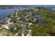 Expansive aerial shot showcasing waterfront homes with private docks, lush greenery, and tranquil canals leading to the open water at 5270 Miller Bayou Dr, Port Richey, FL 34668