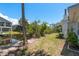 Picturesque backyard with a tranquil pond, lush greenery, and glimpses of the adjacent property, creating a serene oasis at 5270 Miller Bayou Dr, Port Richey, FL 34668