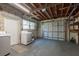 Spacious basement with washer, dryer, garage door, and concrete walls, ready to be customized for your needs at 5270 Miller Bayou Dr, Port Richey, FL 34668