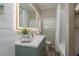 Stylish bathroom featuring a green vanity, sleek fixtures, and a combined shower and bathtub at 5270 Miller Bayou Dr, Port Richey, FL 34668