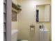 Unique half bathroom featuring a pedestal sink, wood shelf, and painted block walls at 5270 Miller Bayou Dr, Port Richey, FL 34668