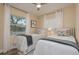 Comfortable bedroom featuring twin beds, natural lighting, and neutral décor for a relaxing atmosphere at 5270 Miller Bayou Dr, Port Richey, FL 34668