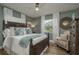 Serene bedroom with a decorative bed frame, neutral walls, and abundant natural light at 5270 Miller Bayou Dr, Port Richey, FL 34668