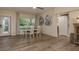 Open dining area with views of the outdoors, wood flooring, and elegant decor at 5270 Miller Bayou Dr, Port Richey, FL 34668