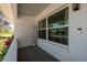 Charming front porch with large windows, a welcome sign, and outdoor seating at 5270 Miller Bayou Dr, Port Richey, FL 34668