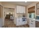 Charming breakfast nook with custom white cabinets, modern microwave and ample counter space at 5270 Miller Bayou Dr, Port Richey, FL 34668