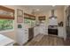 Bright, remodeled kitchen with white cabinets, modern appliances, and plenty of natural light at 5270 Miller Bayou Dr, Port Richey, FL 34668