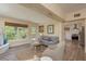 Bright and airy living room featuring neutral decor, wood-look floors, and seamless kitchen access at 5270 Miller Bayou Dr, Port Richey, FL 34668