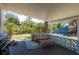 Cozy covered patio featuring comfortable seating, a rug, and an outdoor grill, perfect for relaxing and entertaining at 5270 Miller Bayou Dr, Port Richey, FL 34668