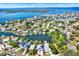 Panoramic aerial view of waterfront home with solar panels, dock, and lush landscaping on a sunny day at 5331 Bayou Grande Ne Blvd, St Petersburg, FL 33703