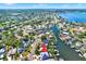 Aerial view of a charming waterfront home with solar panels surrounded by lush trees and water access at 5331 Bayou Grande Ne Blvd, St Petersburg, FL 33703
