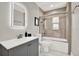 Well-lit bathroom featuring a shower-tub combo with glass doors and modern vanity at 5331 Bayou Grande Ne Blvd, St Petersburg, FL 33703