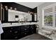 Modern bathroom with double vanity, stylish light fixtures and decor, with a bench by a window at 5331 Bayou Grande Ne Blvd, St Petersburg, FL 33703