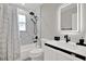 Bright bathroom featuring modern fixtures, a bathtub shower combo and a vanity with storage at 5331 Bayou Grande Ne Blvd, St Petersburg, FL 33703
