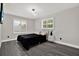 Serene bedroom with modern light fixture, shutters and stylish gray flooring at 5331 Bayou Grande Ne Blvd, St Petersburg, FL 33703