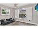Cozy bedroom with plantation shutters, grey wood floors and a mounted TV at 5331 Bayou Grande Ne Blvd, St Petersburg, FL 33703