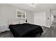 Comfortable bedroom featuring plantation shutters, grey floors, and ample closet space at 5331 Bayou Grande Ne Blvd, St Petersburg, FL 33703