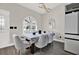 Elegant dining area featuring stylish chairs, modern table setting, and arched window with plenty of natural light at 5331 Bayou Grande Ne Blvd, St Petersburg, FL 33703