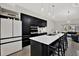 Modern kitchen with white countertop island, sleek black cabinetry and stainless steel appliances at 5331 Bayou Grande Ne Blvd, St Petersburg, FL 33703