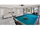 Bright living room with a pool table and comfortable seating area at 5331 Bayou Grande Ne Blvd, St Petersburg, FL 33703