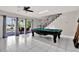 Bright living room with a pool table and access to the patio and pool area at 5331 Bayou Grande Ne Blvd, St Petersburg, FL 33703