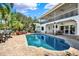 Inviting backyard pool with brick paver patio and outdoor seating, perfect for relaxation and entertaining at 5331 Bayou Grande Ne Blvd, St Petersburg, FL 33703