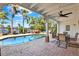 Enjoy waterfront views from this covered patio with outdoor dining by the beautiful backyard pool at 5331 Bayou Grande Ne Blvd, St Petersburg, FL 33703