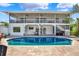 A rear view of the home showcasing a beautiful pool, patio, and screened in porch at 5331 Bayou Grande Ne Blvd, St Petersburg, FL 33703
