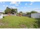 Large backyard, wooden fence, green lawn, and playground set at 5961 41St N Ave, St Petersburg, FL 33709