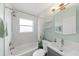 Bathroom with tub, shower and modern vanity with excellent lighting at 5961 41St N Ave, St Petersburg, FL 33709