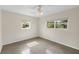 Bright bedroom features neutral walls, ceiling fan, and windows that offer natural light at 5961 41St N Ave, St Petersburg, FL 33709