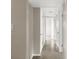 Hallway with neutral paint, tiled floors, and a series of white doors at 5961 41St N Ave, St Petersburg, FL 33709