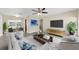 Cozy living room showcases modern furniture, a stylish rug, neutral wall color, and decor; adjacent dining area visible at 5961 41St N Ave, St Petersburg, FL 33709