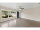 Bright, airy living room features polished floors, a ceiling fan, a large front window and a dark front door at 5961 41St N Ave, St Petersburg, FL 33709