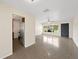 Open living area showcases polished floors, a view into the kitchen, and a large window; bright and airy atmosphere at 5961 41St N Ave, St Petersburg, FL 33709